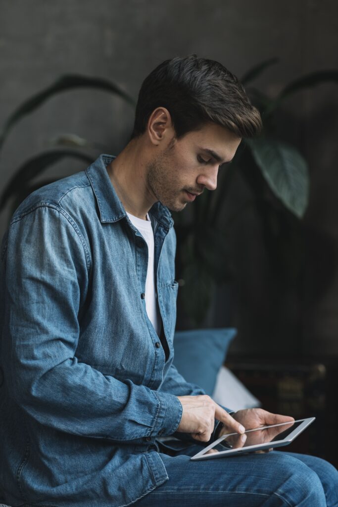 young-man-blue-denim-shirt-using-digital-tablet (1)